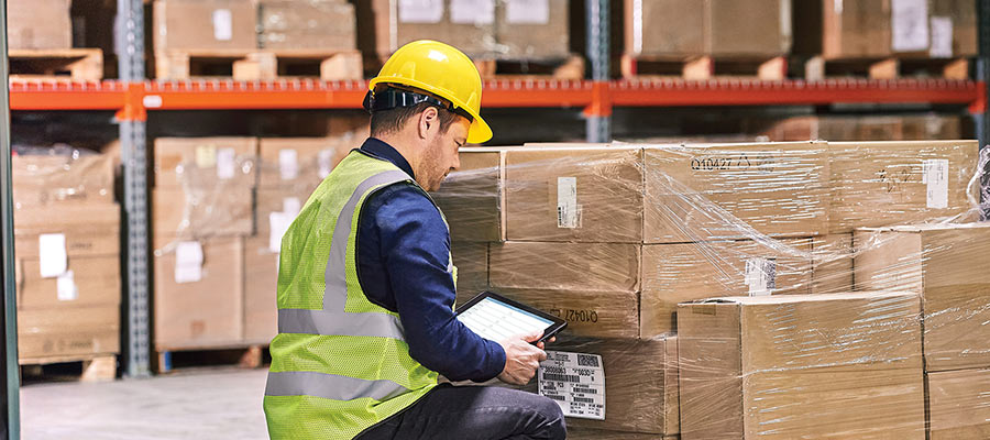 Hard-hat warehouse worker using Zebra mobile computer